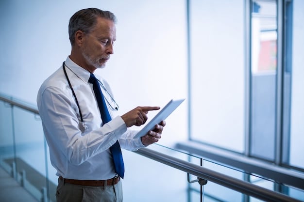A doctor in a modern hospital setting reviewing patient data and analytics on a tablet, illustrating the impact of data analytics in the US healthcare industry.