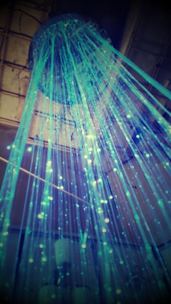 An abstract representation of data flowing through a smart home network, highlighting potential vulnerabilities and security breaches with visual cues.