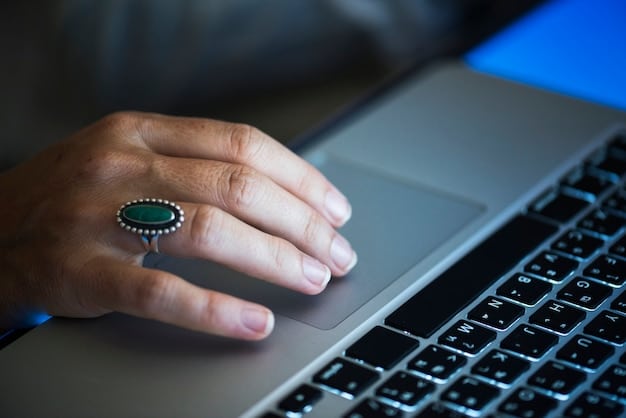 A close-up shot of a person using a password manager on their laptop, illustrating the importance of cybersecurity in remote work.