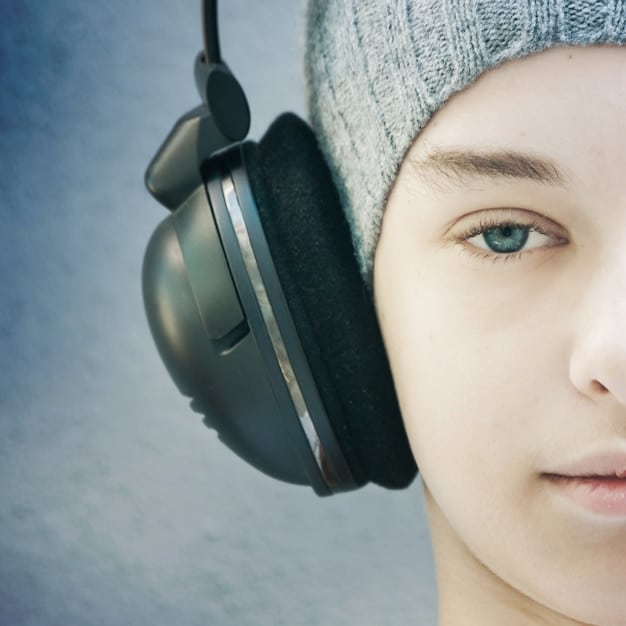 A close-up of noise-canceling headphone earcup showing the microphone used for active noise cancellation depicted with a clear and detailed view highlighting the technology within the headphone.
